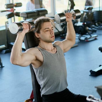 man working out using dumbbells