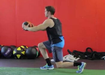 man practicing a medicine ball lunge