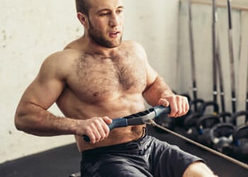 man using a row cable inside a gym