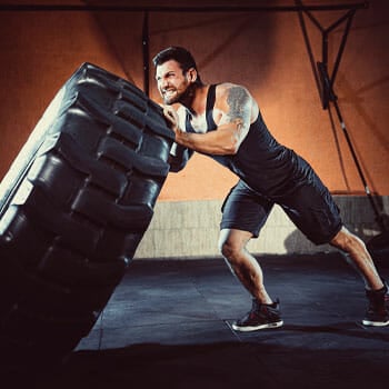 man moving a huge tire