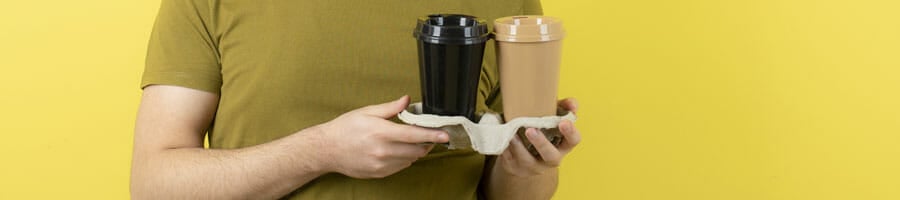 man holding a tray of coffee cups