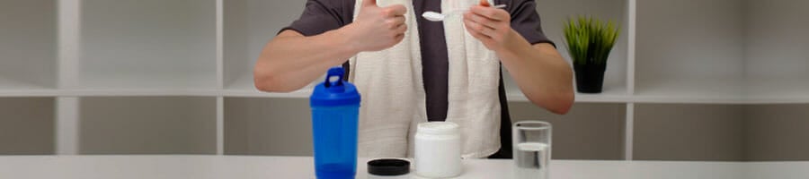 man scooping a protein powder from container