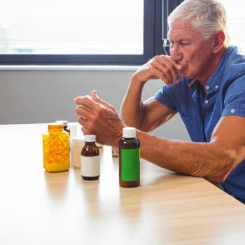 man looking through his supplements