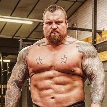 portrait image of a shirtless eddie hall in gym