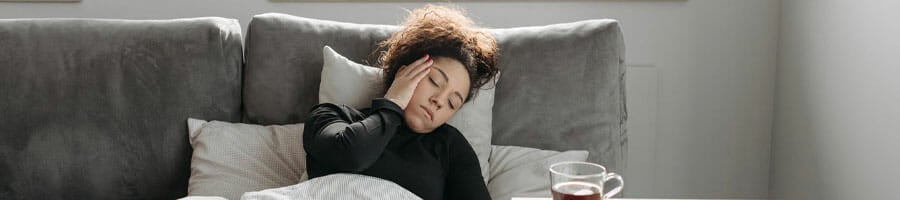 tired woman laying on the couch