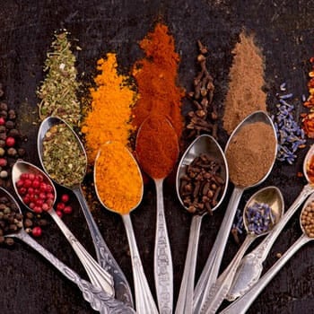 different types of powder ingredients on a stack of spoons