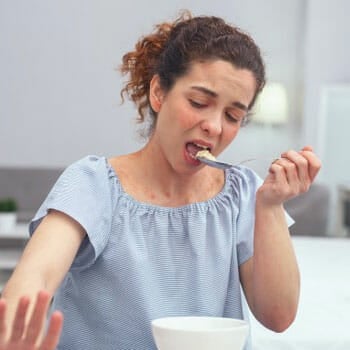 woman eating food in the kitchen