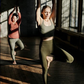 women practicing yoga inside a yoga studio