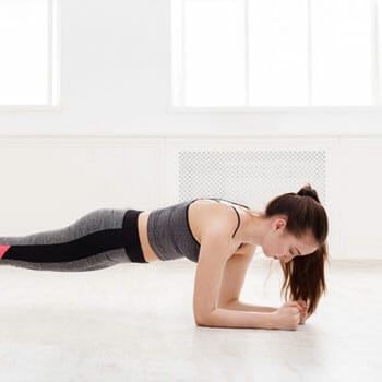 woman in a plank position at home