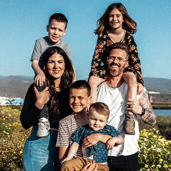 A family smiling in front of the camera