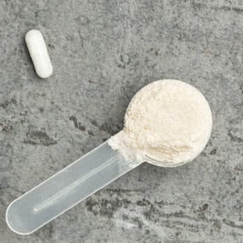 A pill and a scoop of powdered supplement