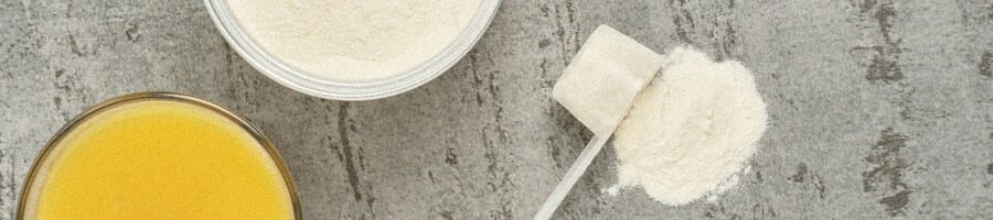 A spoon of a powdered supplement spilled on a table