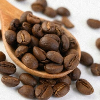 Coffee beans on a wooden spoon