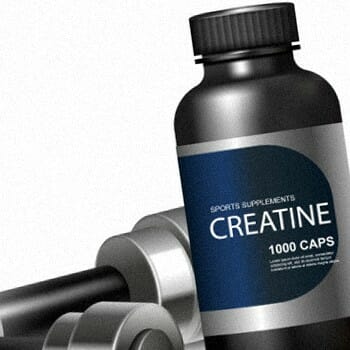 A bottle of Creatine with dumb bells on its side