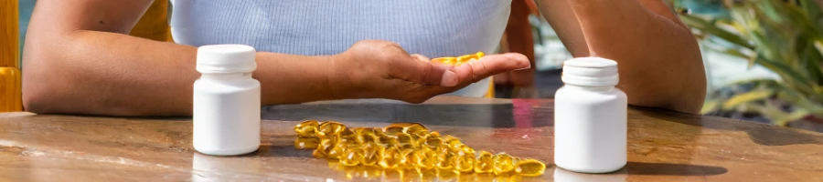 A person holding a piece of fish oil