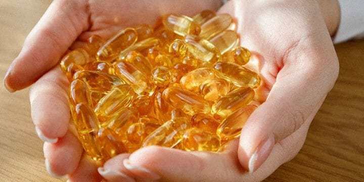 Fish oil supplement on hand