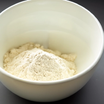 Mass gainer powder on a white bowl