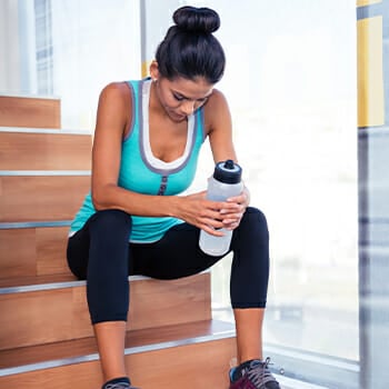 A woman taking a rest beside the stairs