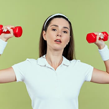 A woman lifting a small dumb bells