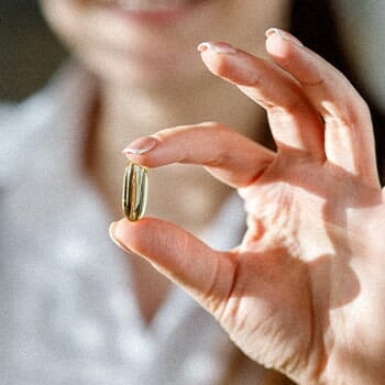 A close up image of holding a piece of fish oil capsule