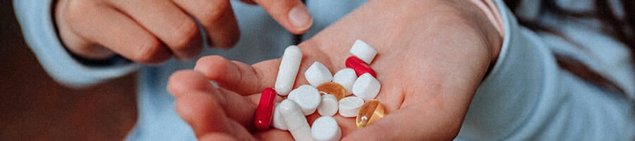 Different multivitamins on a person's hand
