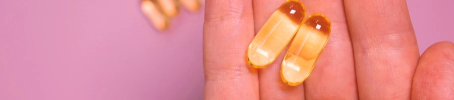 A woman with vitamins on her hand