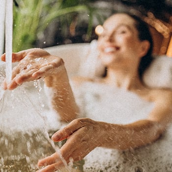 A woman relaxing in her bath tub