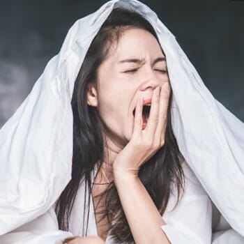 A yawning exhausted woman