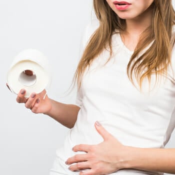 A woman holding a toilet paper and stomach