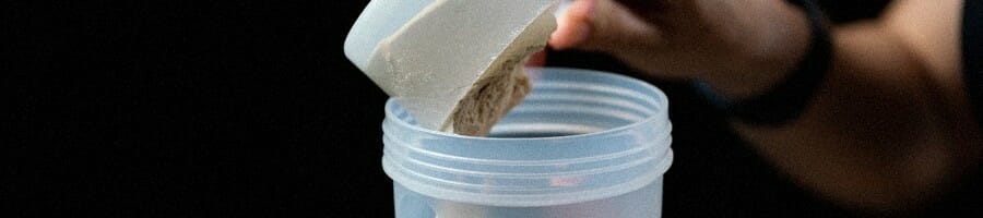 Pouring a powdered creatine on a container