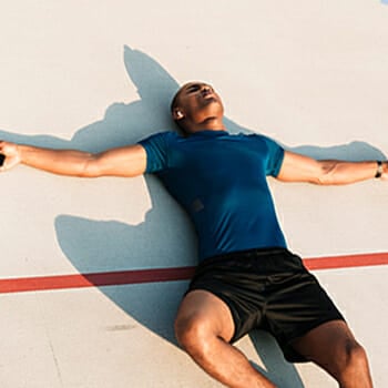 An exhausted guy resting on floor