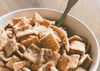 Cinnamon Toast Crunch in a white bowl with a spoon
