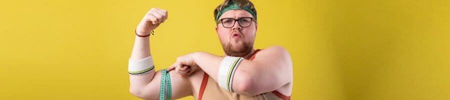 man using a measuring tape on his flexed biceps