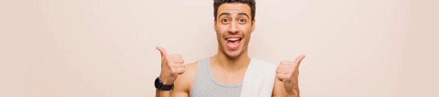 man in a tank top raising a thumbs up