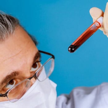 medical person holding up a blood sample