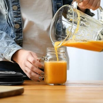 jar getting filled with a smoothie from a blender