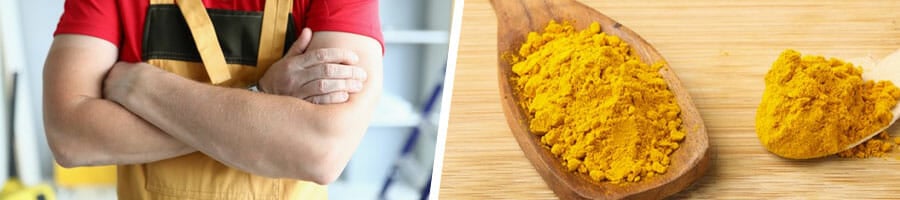 man with his arms crossed, two spoons filled with turmeric powder