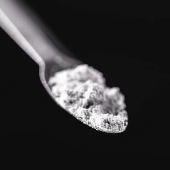 white powder filled spoon