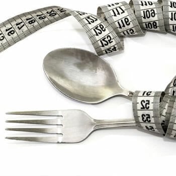 measuring tape wrapping both spoon and fork