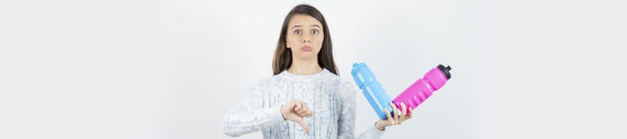 woman with her thumbs down while holding two jugs