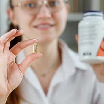 woman showing a capsule on her hand