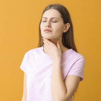 woman with her hand on her neck while her eyes are close