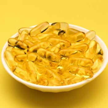 fish oil capsules filling a bowl