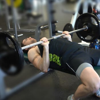 man lifting barbells in a close grip