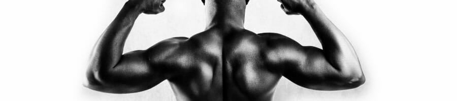 black man in black and white showing off his back muscles