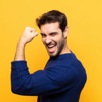 happy man in a sweater showing off his biceps
