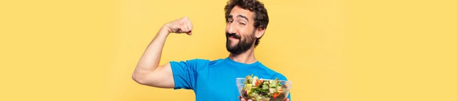 man flexing his biceps while holding a bowl of salad