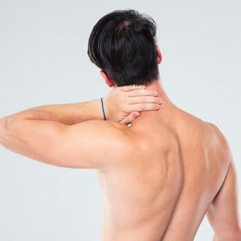 man showing his back and grabbing his nape