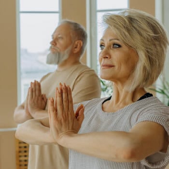 old couple doing yoga together