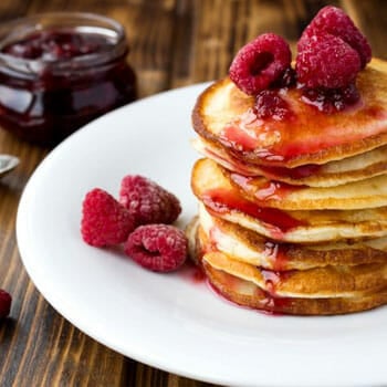 plate filled with pancakes and berries